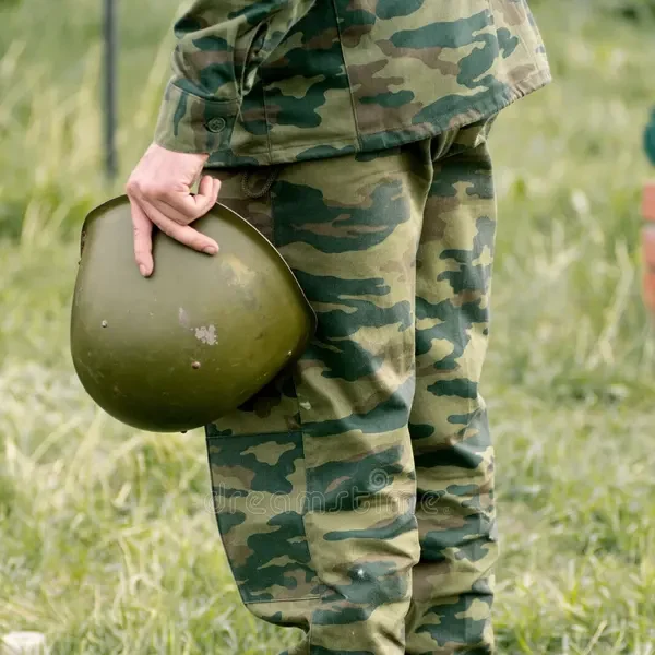 soldier holding helmet